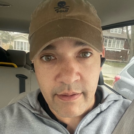 A portrait of Ted parks, a man in the driver seat of his car