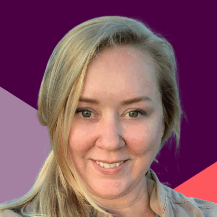 A young white woman smiles before a purple and coral angled background.