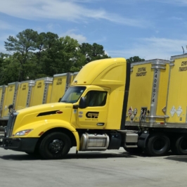 Central Transport yellow big rig trucks lined up.