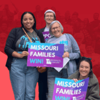 A small group of advocates from Missouri Jobs with Justice carry 'Missouri Families Win' posters in support of raising the minimum wage.